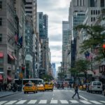Vibrant street view of New York City with pedestrians, yellow cabs, and skyscrapers.